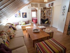 a living room with a couch and a table at Moonlight House Large holiday villa with sauna and free parking in Rovaniemi