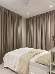1 dormitorio con 1 cama blanca grande con cortinas en Lovely Continew Residence 2 Bedrooms - KL, en Kuala Lumpur