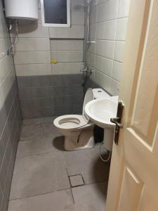 a bathroom with a toilet and a sink at A Luxury 2 Bedroom With a perfect location in Sweifiyeh in Amman