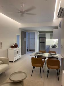 a kitchen and living room with a table and chairs at Lovely Continew Residence 2 Bedrooms - KL in Kuala Lumpur