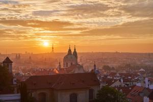 a view of a city with the sunset in the background at SKY SUITE HOTEL in Prague