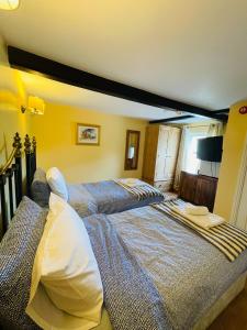 a bedroom with two beds in a room at The Boat Inn Hayton in Retford