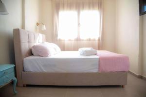 a bedroom with a bed with two pillows and a window at Zennova #61, Boutique Studio in Nikiti in Nikiti