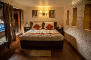 a bedroom with a bed and a brick wall at Hotel Traditional in Bhaktapur