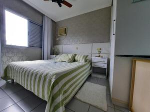 a small bedroom with a bed and a window at Linda Cobertura Piscina Privativa na Divina Caiobá - Somente Familiares in Matinhos +29 photos
