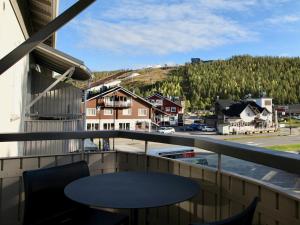 a balcony with a table and a view of a town at Levi Way 1 in Levi