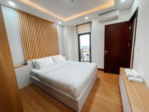 a small bedroom with a bed and a window at 2 Bedrooms Permata Hijau Suites Apartment in Jakarta