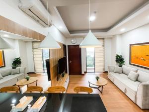 a living room with a couch and a table at 2 Bedrooms Permata Hijau Suites Apartment in Jakarta