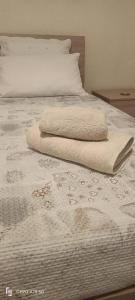 ein weißes Bett mit zwei Handtüchern darüber in der Unterkunft B&B LEO'S in Cagliari