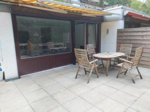 a patio with a table and chairs on a patio at Ferienwohnung in Hitzacker in Hitzacker