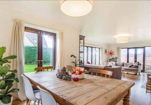 a large living room with a wooden table and chairs at Island Retreat in West Mersea