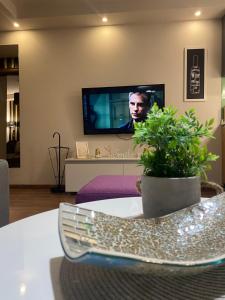 a living room with a tv and a table at Apartman KulTurista in Zlatibor