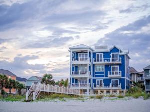 a blue building on the beach with condos at Huge Beachfront Home with Pool, Hot Tub, Elevator- 4 night minimum stay in Myrtle Beach