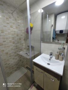 a bathroom with a shower and a white sink at Apartman KulTurista in Zlatibor +22 photos