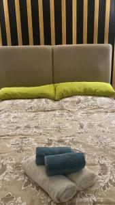 a bed with a blanket and pillows on it at Apartman KulTurista in Zlatibor