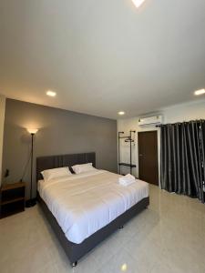 a bedroom with a large white bed in a room at see-on place/สีอ่อนเพลส in Ban Tha Phae