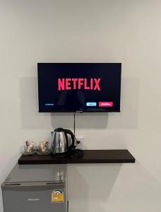 a tv on a wall with a netflix sign on it at see-on place/สีอ่อนเพลส in Ban Tha Phae