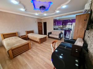 a living room with two beds and a couch at Gricko in Tbilisi City
