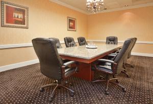 a conference room with a large table and chairs at Holiday Inn Lumberton by IHG in Lumberton