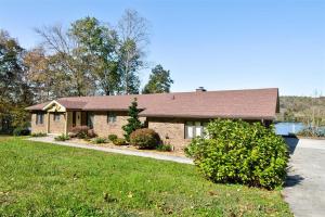 a brick house with a brown roof at Melton Away - Knoxville/Oak Ridge in Knoxville