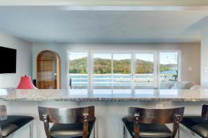 a kitchen with a bar with chairs and a view of the ocean at Melton Away - Knoxville/Oak Ridge in Knoxville