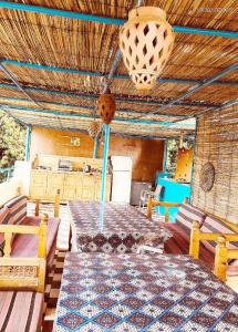 a room with a bed, chairs, and a table at Nubian Holiday House Aswan in Aswan