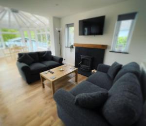 a living room with a couch and a fireplace at Mary Cottage, Braunton, Devon in Braunton