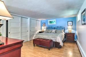1 dormitorio con paredes azules, 1 cama y 1 mesa en Charming Cape Cod Apartment 2 Mi to Monument Beach, en Bourne