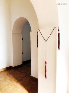 a hallway with a white wall and an archway at Nubian Holiday House Aswan in Aswan