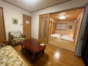 a living room with a mirror in the middle of a room at HOCO Kawaguchiko in Azagawa