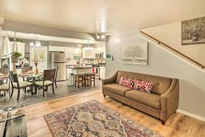 a living room with a couch and a dining room at Fort Worth Retreat with Fenced Yard and Fire Pit! in Fort Worth
