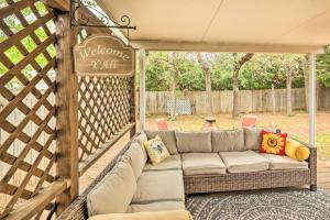 a couch sitting on a porch with a sign at Fort Worth Retreat with Fenced Yard and Fire Pit! in Fort Worth