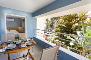 a balcony with a table and chairs and a bed at Analipseos 9 Loft in Kalamata +6 photos