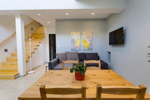 a dining room and living room with a wooden table at Analipseos 9 Loft in Kalamata