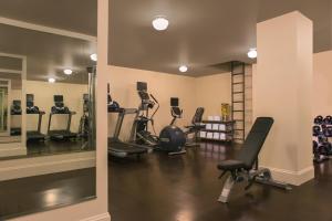 a gym with treadmills and elliptical machines and a mirror at Kimpton Palladian Hotel, an IHG Hotel in Seattle