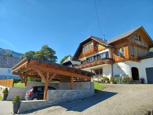 a house with a car parked in front of it at Ferienhaus Bernadette in Mauterndorf