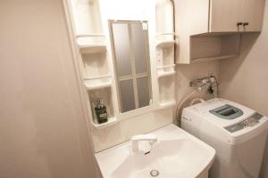 a small bathroom with a toilet and a sink at Bios Hall / Vacation STAY 2175 in Sapporo