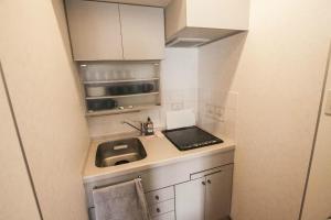 a small kitchen with a sink and a stove at Bios Hall / Vacation STAY 2181 in Sapporo