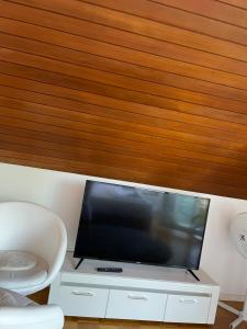 a flat screen tv sitting on top of a white cabinet at FlyHigh Apartment Stuttgart in Stuttgart