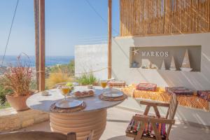 a table on a patio with a view of the ocean at Markos Home in Koutsounari