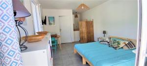 a bedroom with a blue bed in a room at Gite le Chamaju in Labeaume