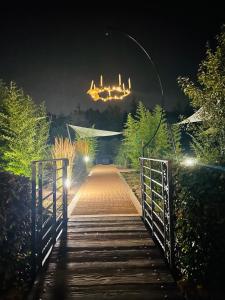 a wooden bridge with a chandelier at night at Locanda in Gessate