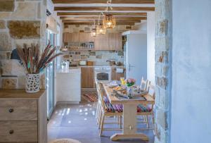 a kitchen with a table and chairs in a room at Markos Home in Koutsounari