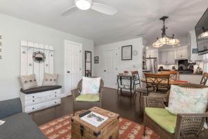 a living room with a couch and chairs and a kitchen at Weeden Cottage in St. Augustine