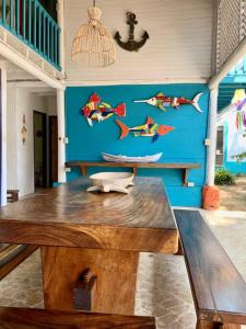 a wooden table in a room with a blue wall at Casita Caribe en reserva natural, playa privada, kayaks, wifi, aire acondicionado in San Onofre