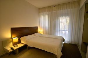 Voodi või voodid majutusasutuse Hotel L'Approdo toas