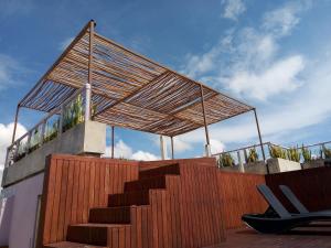 a set of stairs with a wooden fence and a roof at Iris Studios & Apartments in Playa del Carmen
