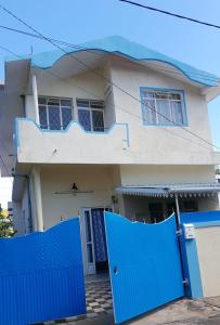 a house with blue gates in front of it at Adorable 2bedroom homestay in Beau Bassin