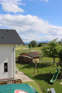 a playground with a slide and a building at Hotel Garni Austermayer in Traunreut