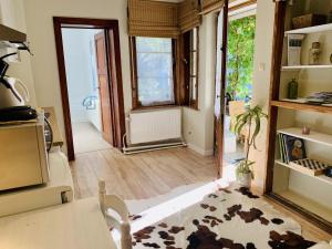 a living room with a door open to a kitchen at Gîte: À la courbe du fleuve in Godinne